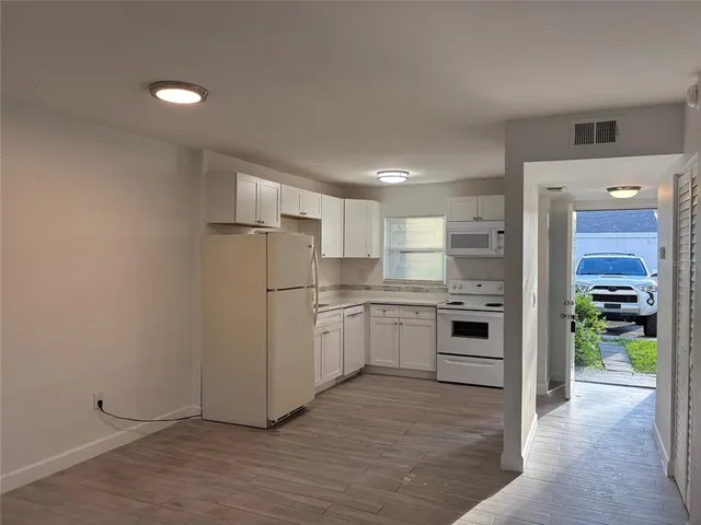 a kitchen with a refrigerator and a stove