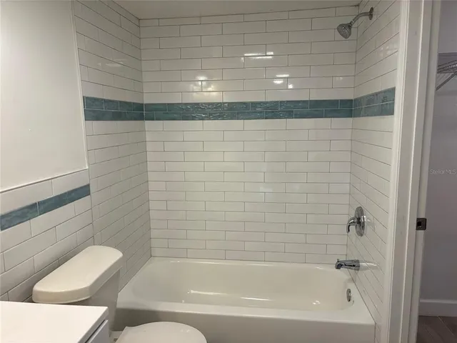 a bathroom with a bathtub and shower