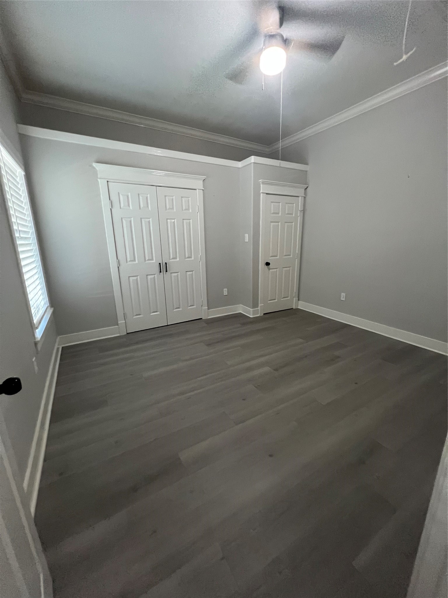 220 Redan Street, Unit A Houston, TX 77009 - Photo 20 of 22 en empty room with wooden floor and fan