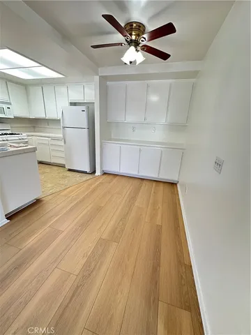 a view of a kitchen with wooden floor and a sink