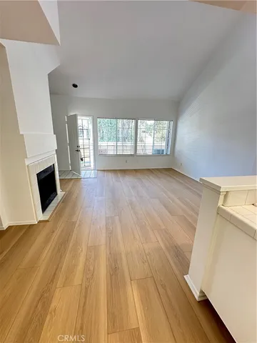 wooden floor in an empty room with a fireplace