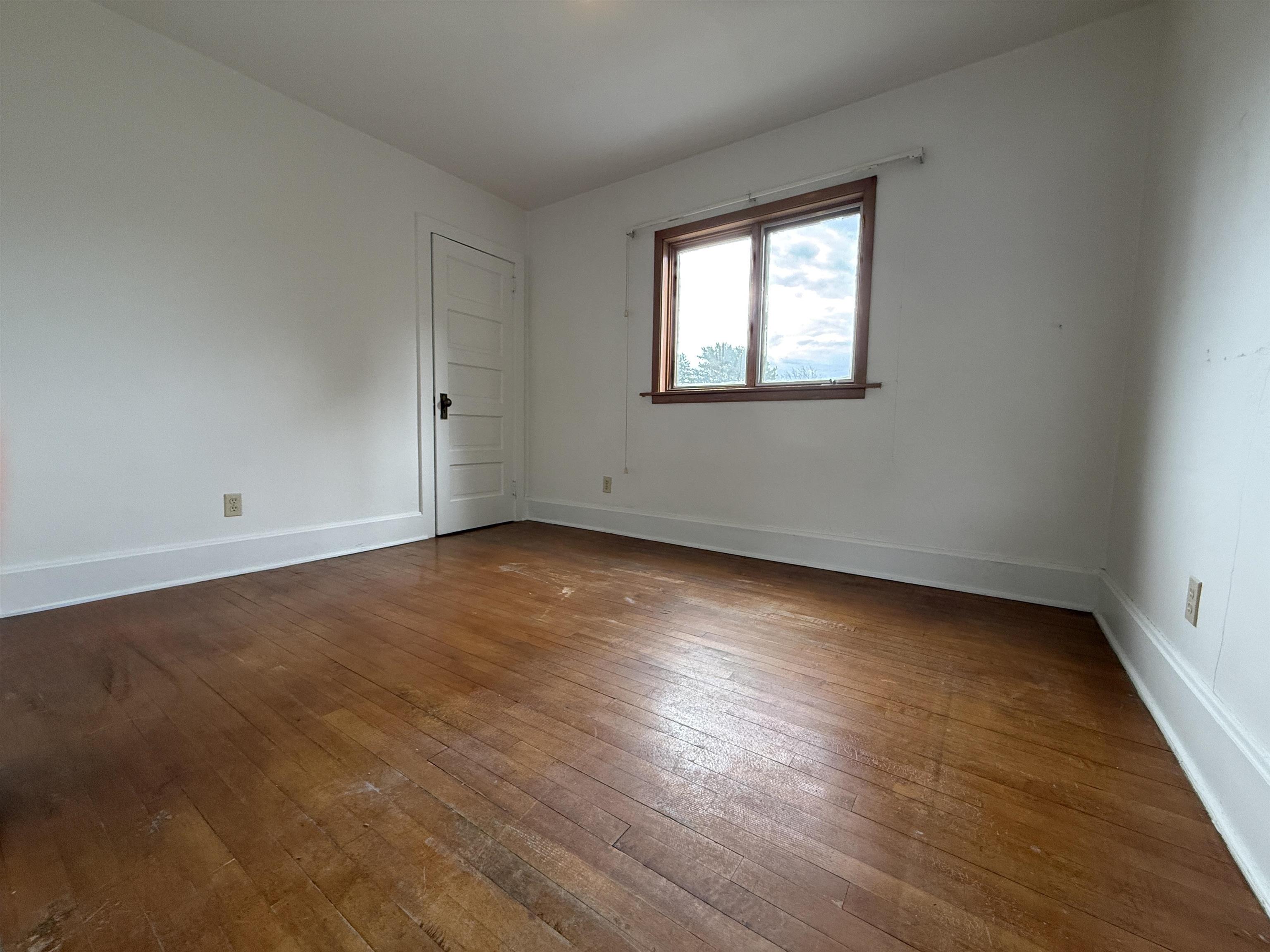 214 8th Street Southwest Chisholm, MN 55719 - Photo 19 of 25 Unfurnished room featuring baseboards and hardwood / wood-style floors
