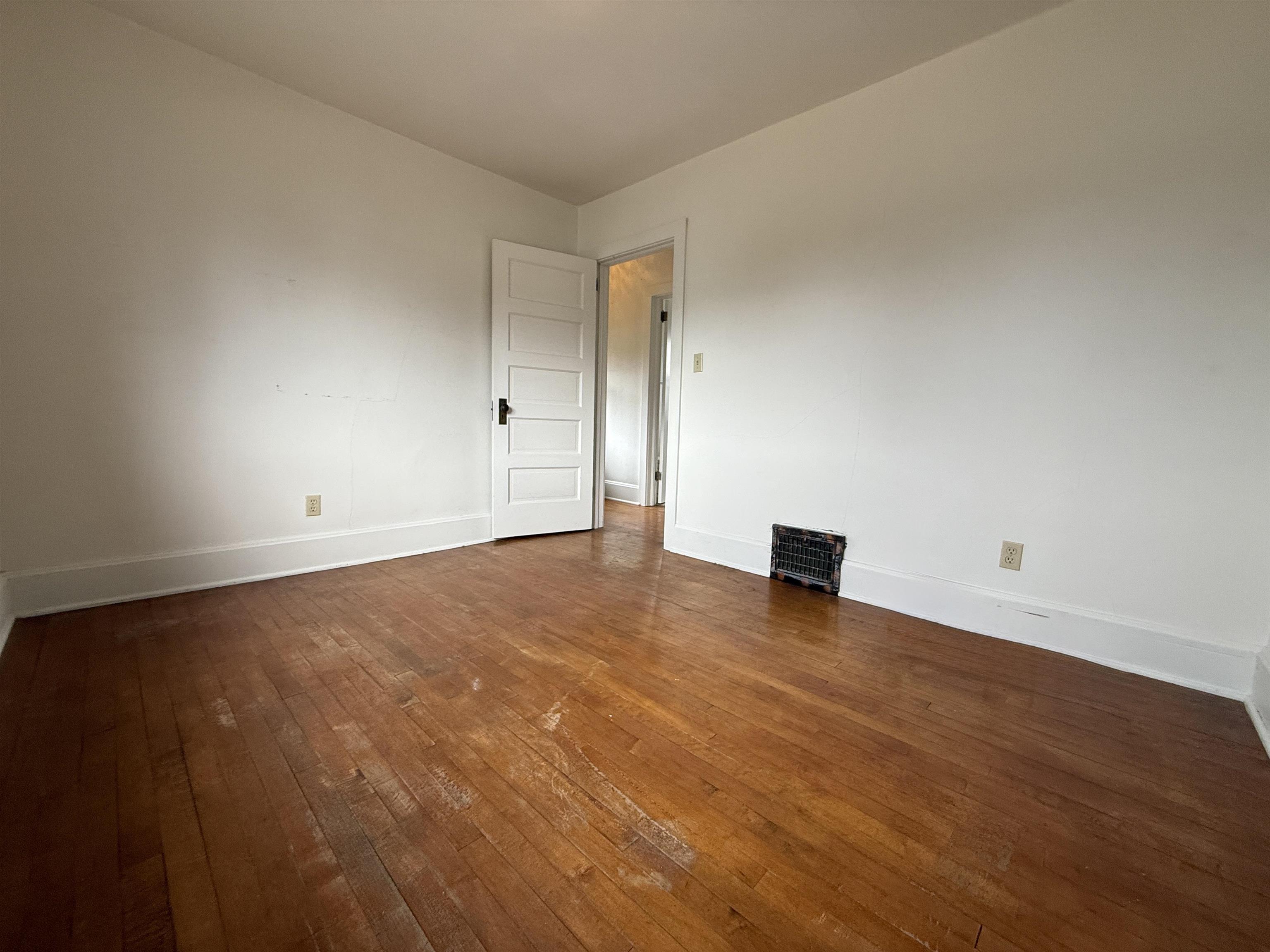 214 8th Street Southwest Chisholm, MN 55719 - Photo 20 of 25 Empty room with dark wood-type flooring and baseboards