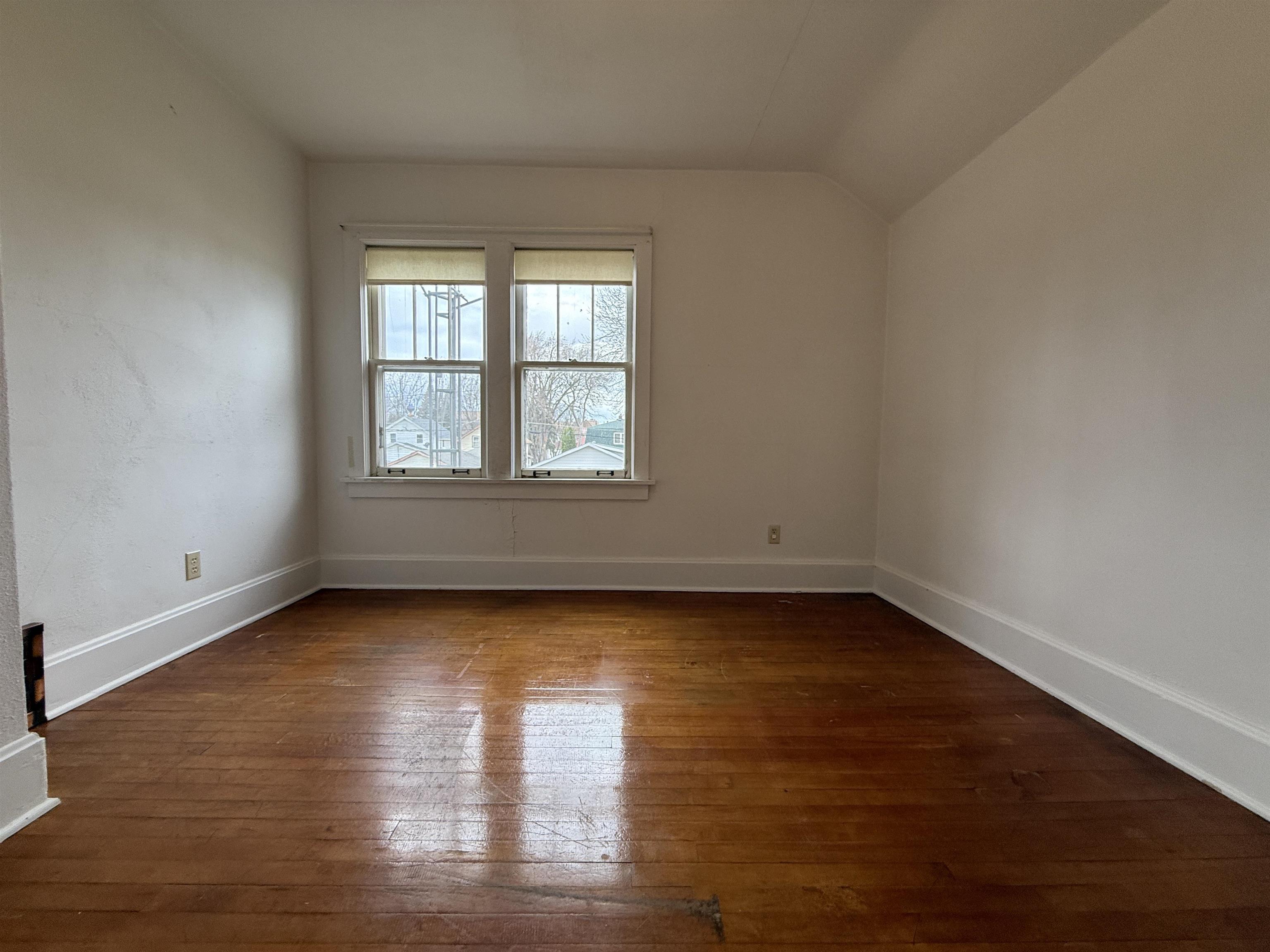 214 8th Street Southwest Chisholm, MN 55719 - Photo 21 of 25 Unfurnished room with dark wood-style flooring and lofted ceiling