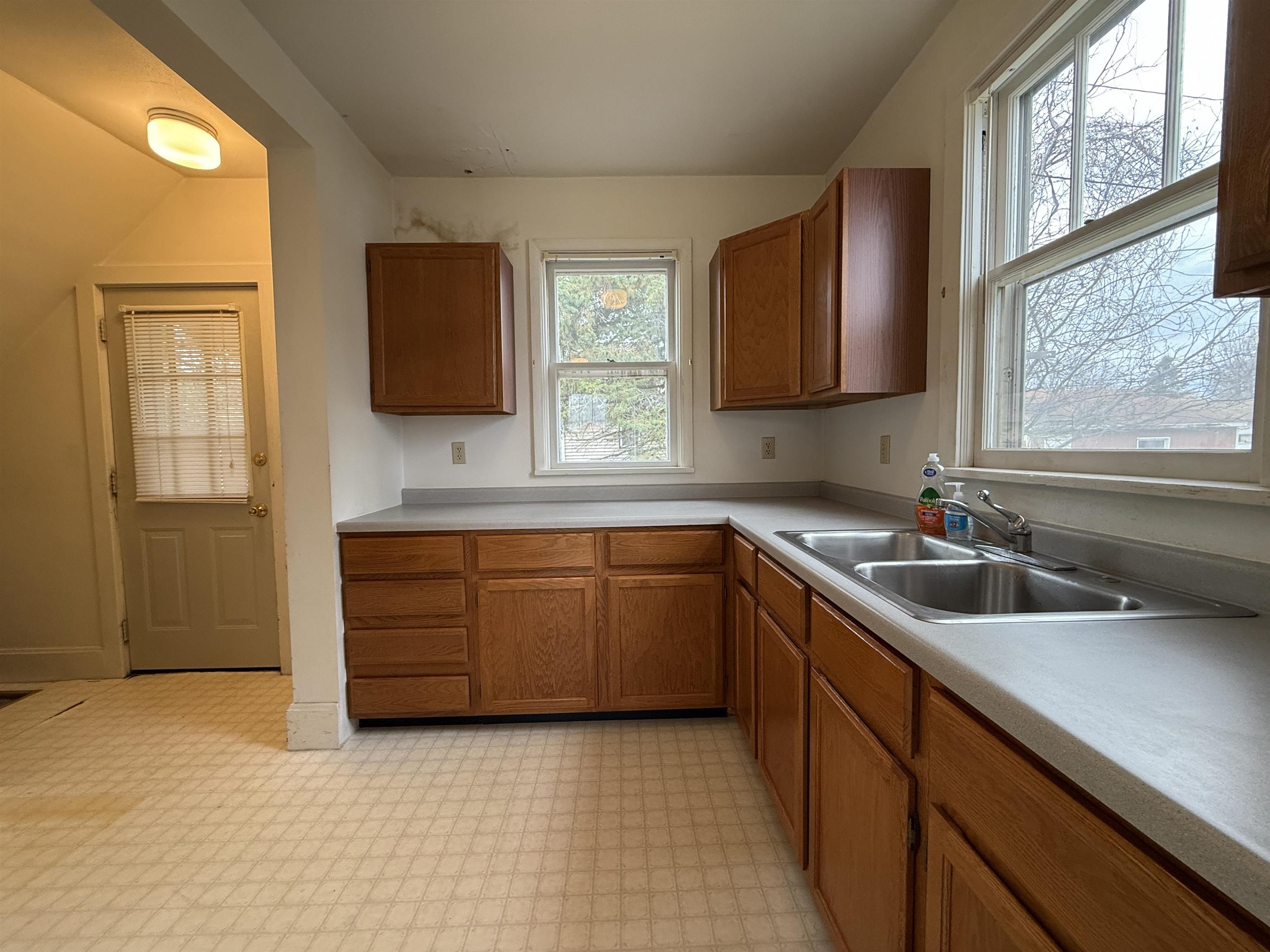 214 8th Street Southwest Chisholm, MN 55719 - Photo 8 of 25 Kitchen with brown cabinetry, light countertops, and light floors