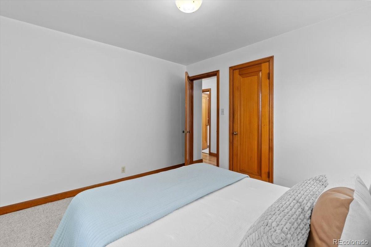 4095 Quay Street Wheat Ridge, CO 80033 - Photo 13 of 32 a bedroom with a bed in it