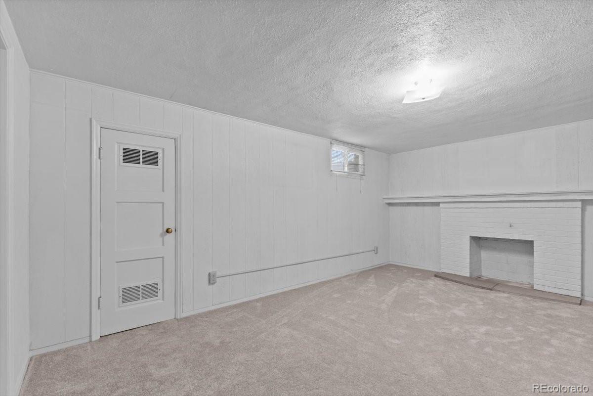 4095 Quay Street Wheat Ridge, CO 80033 - Photo 18 of 32 a view of an empty room and a fireplace