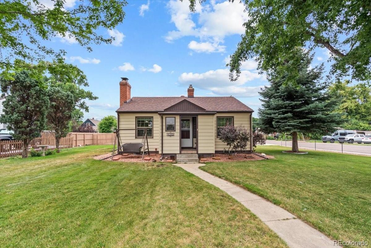 4095 Quay Street Wheat Ridge, CO 80033 - Photo 2 of 32 a front view of house with yard barbeque and outdoor seating