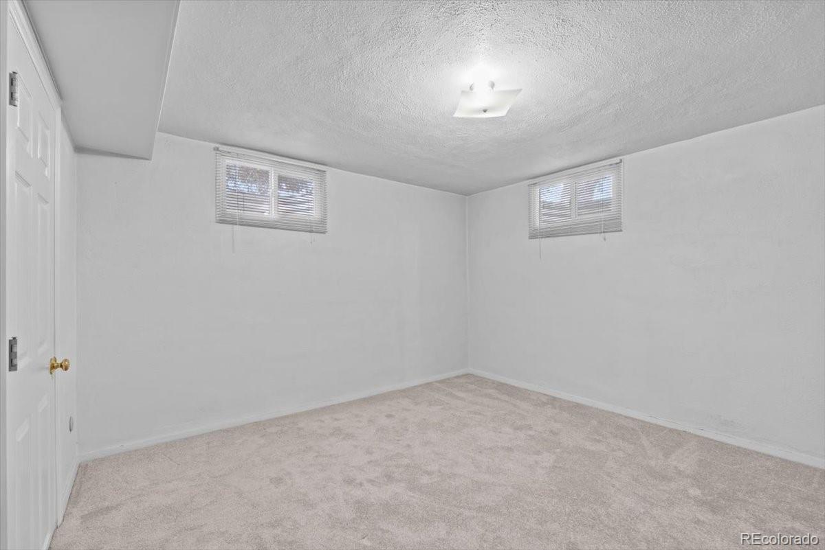 4095 Quay Street Wheat Ridge, CO 80033 - Photo 21 of 32 an empty room with a empty space and windows