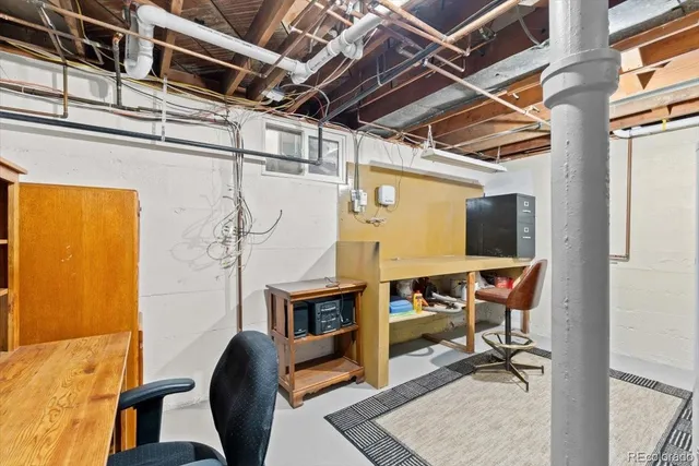 a view of a livingroom with workspace and windows