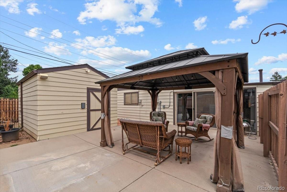 4095 Quay Street Wheat Ridge, CO 80033 - Photo 24 of 32 a view of a patio with table and chairs and potted plants