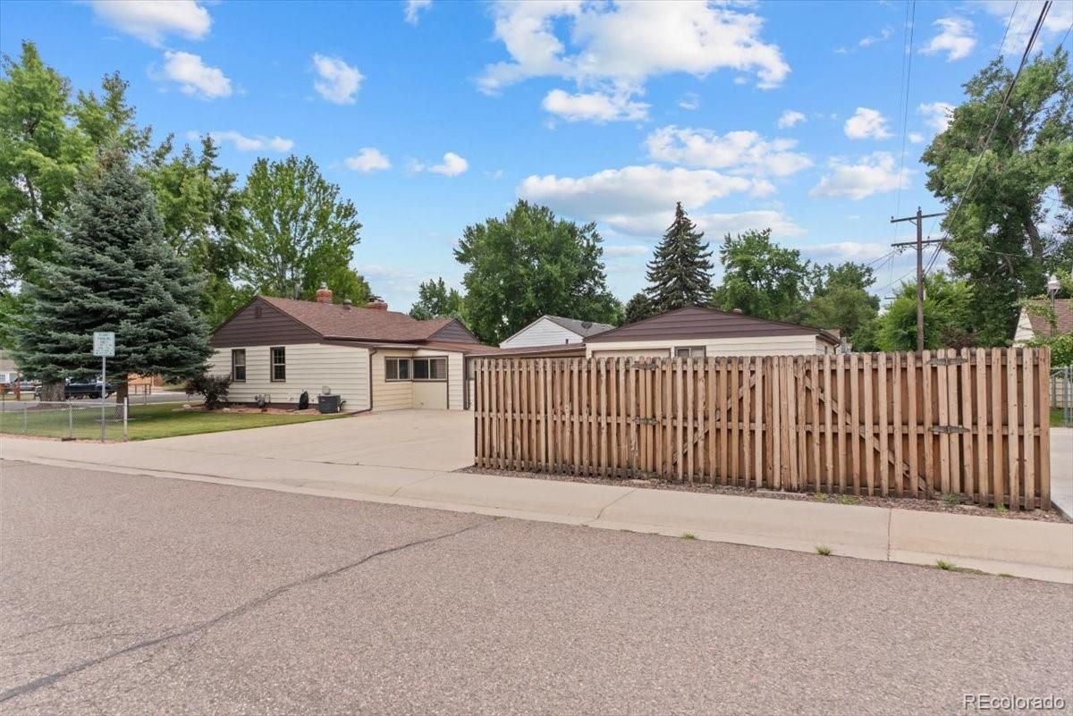 4095 Quay Street Wheat Ridge, CO 80033 - Photo 25 of 32 a view of a house with a wooden fence