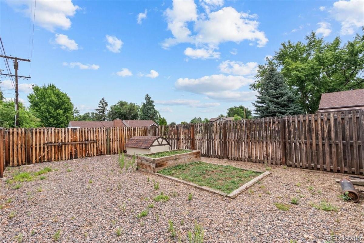 4095 Quay Street Wheat Ridge, CO 80033 - Photo 26 of 32 a view of a backyard with wooden fence