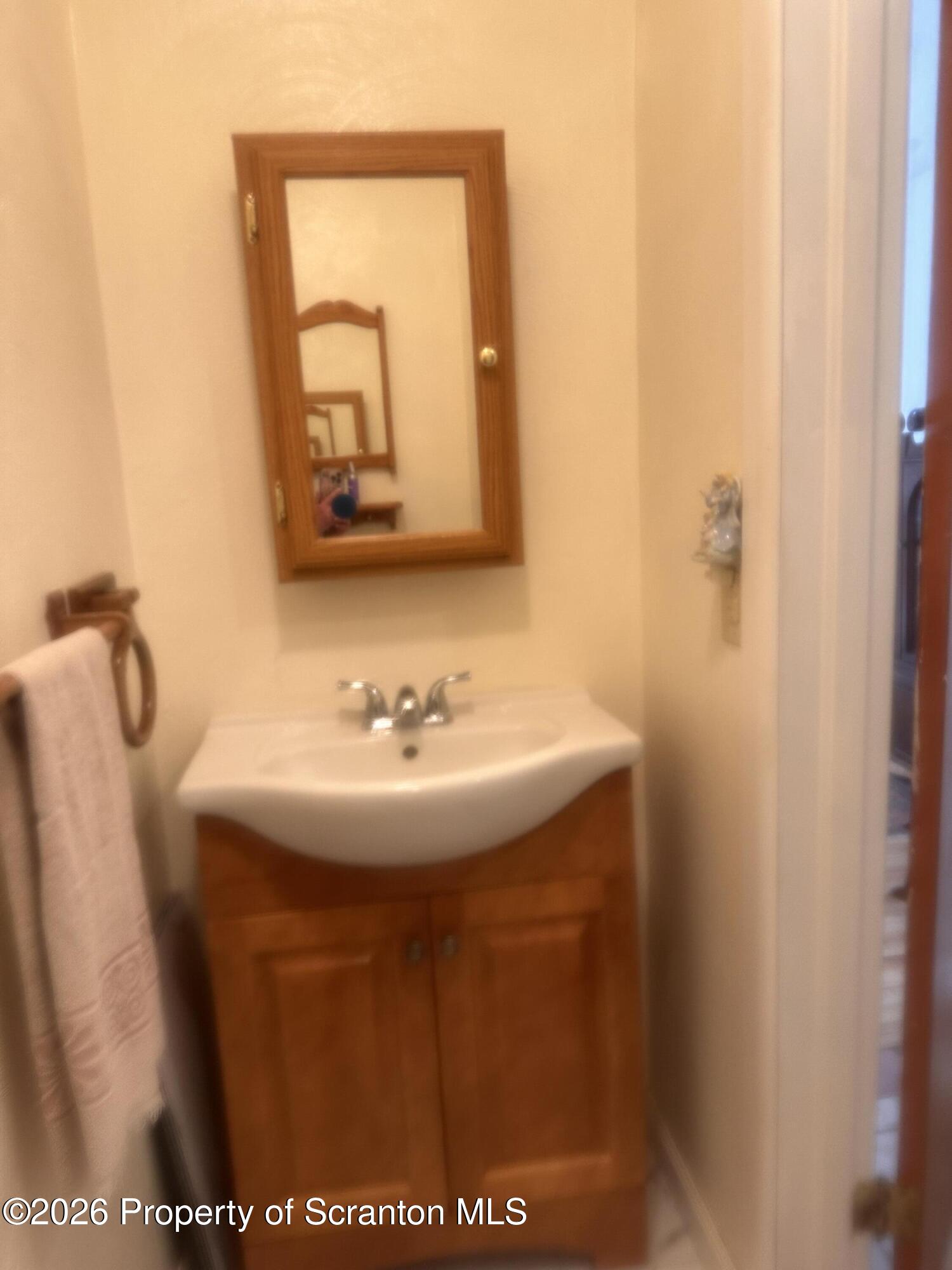 107 Keystone Hls Road, Unit 405 Factoryville, PA 18419 - Photo 16 of 27 a bathroom with a sink and mirror