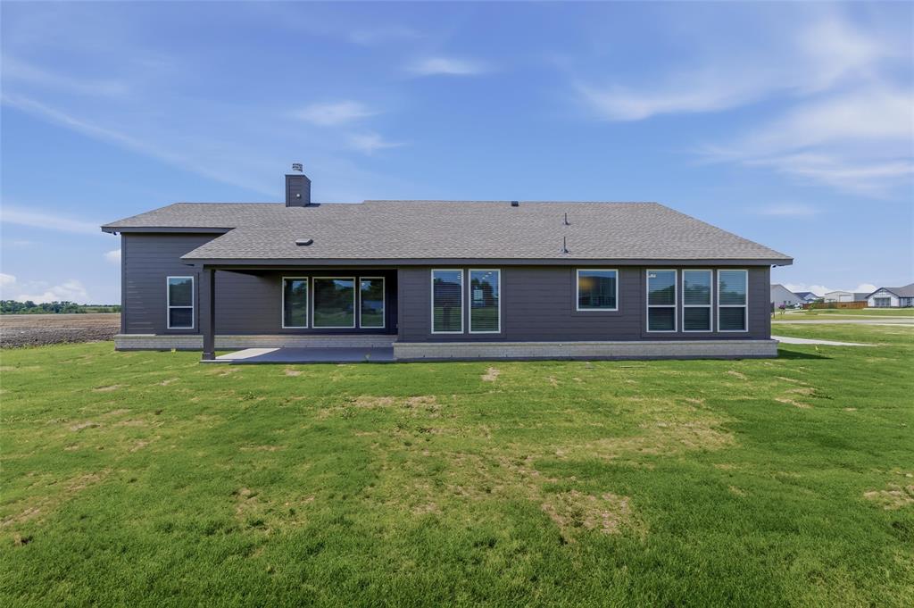 2627 Witness Tree Road Terrell, TX 75161 - Photo 25 of 27 a front view of a house with a garden