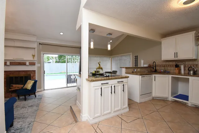a kitchen with stainless steel appliances kitchen island granite countertop a sink and cabinets