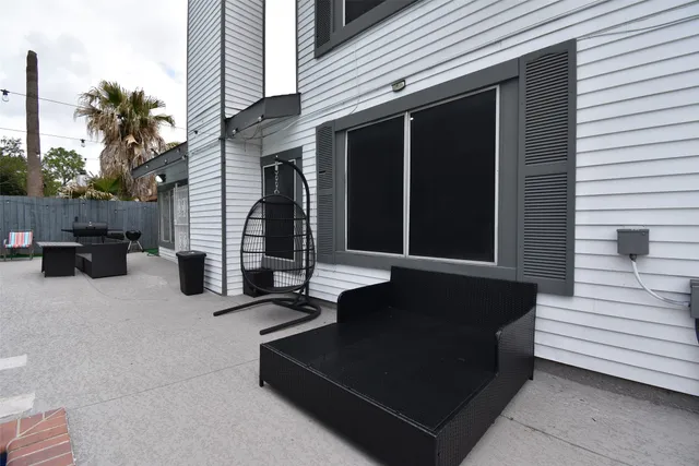 a view of a patio with a table and chairs