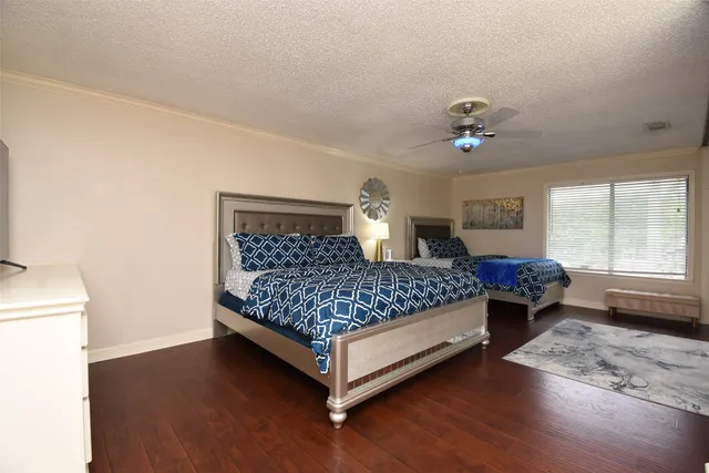 a spacious bedroom with a bed and a chandelier