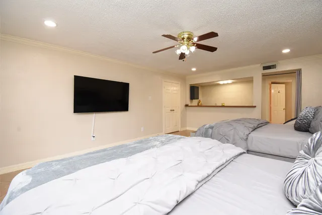 a bedroom with a bed and a flat screen tv