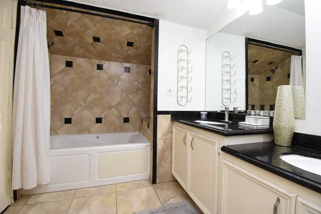 a bathroom with a granite countertop sink a toilet and a mirror