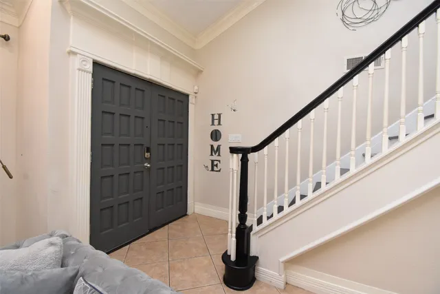 a view of a livingroom with furniture stairs wooden floor and windows