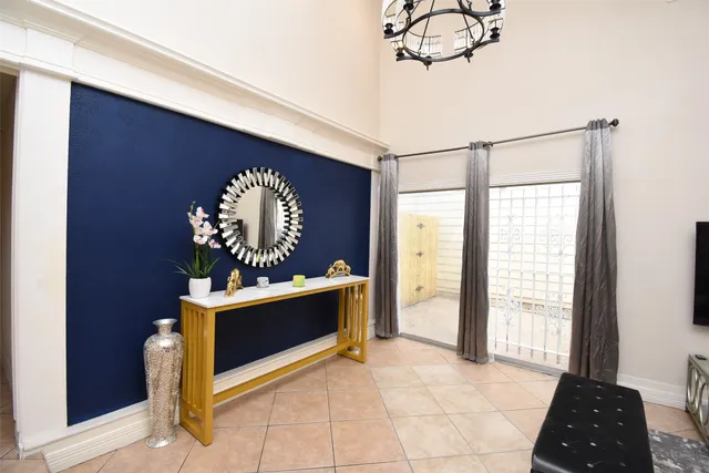 a living room with chairs and a rug