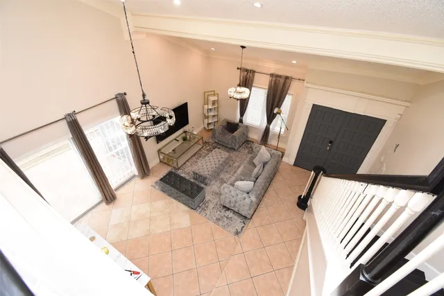a living room with furniture and a chandelier