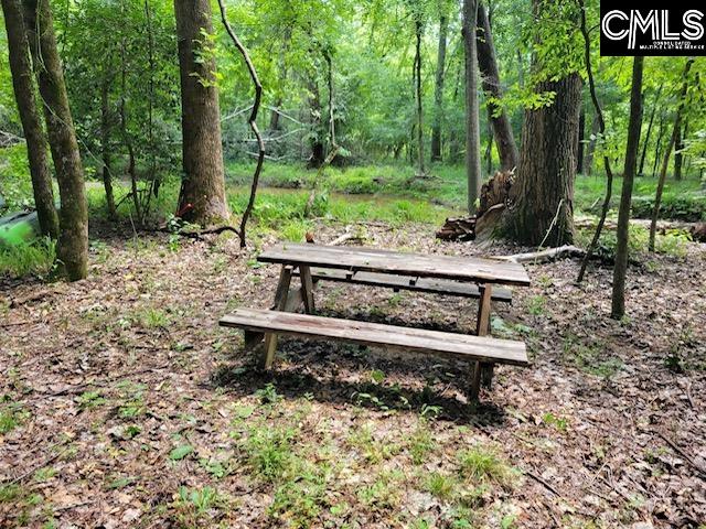 317 Horse Cove Road Gilbert, SC 29054 - Photo 37 of 93 a wooden bench sitting in the middle of a forest