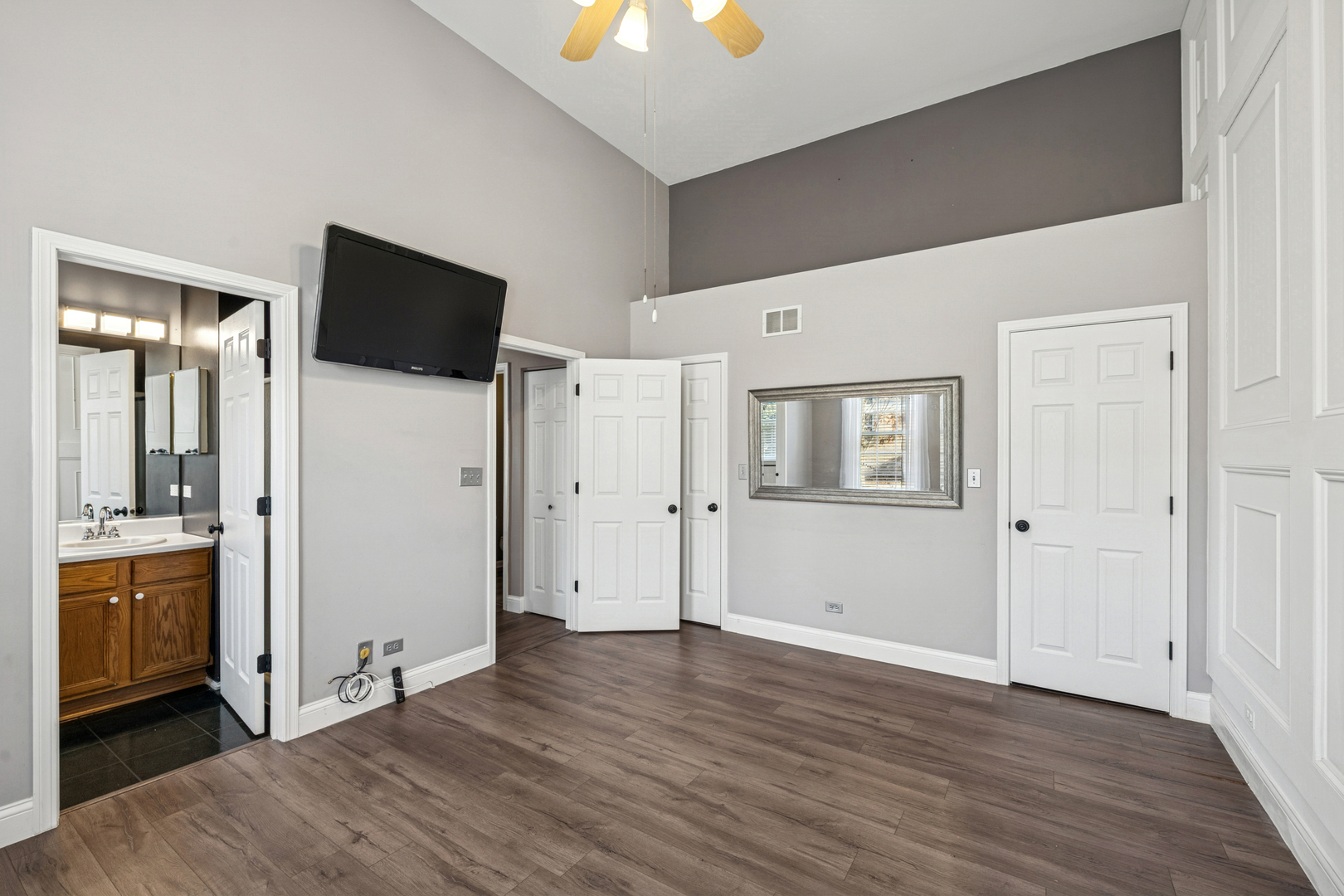 651 Georgian Court Addison, IL 60101 - Photo 11 of 24 an empty room with wooden floor cabinet and windows