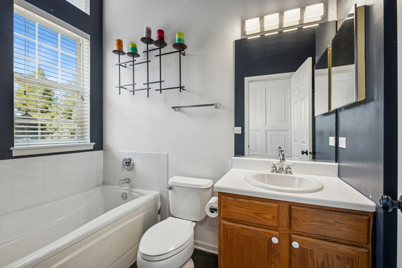 651 Georgian Court Addison, IL 60101 - Photo 12 of 24 a bathroom with a sink a toilet and shower