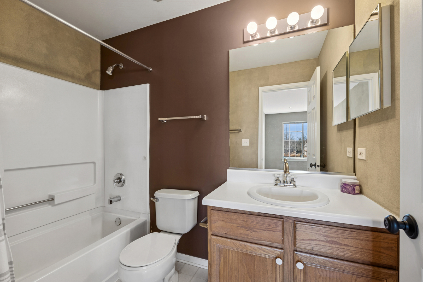 651 Georgian Court Addison, IL 60101 - Photo 18 of 24 a bathroom with a sink toilet a mirror and shower