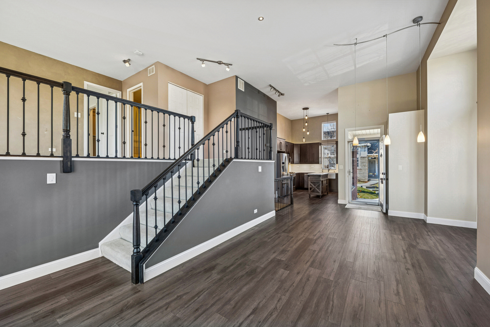 651 Georgian Court Addison, IL 60101 - Photo 2 of 24 a view of a hallway with wooden floor and staircase