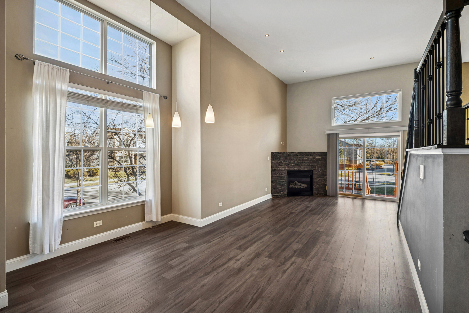 651 Georgian Court Addison, IL 60101 - Photo 3 of 24 a view of a livingroom with wooden floor kitchen view and a fireplace