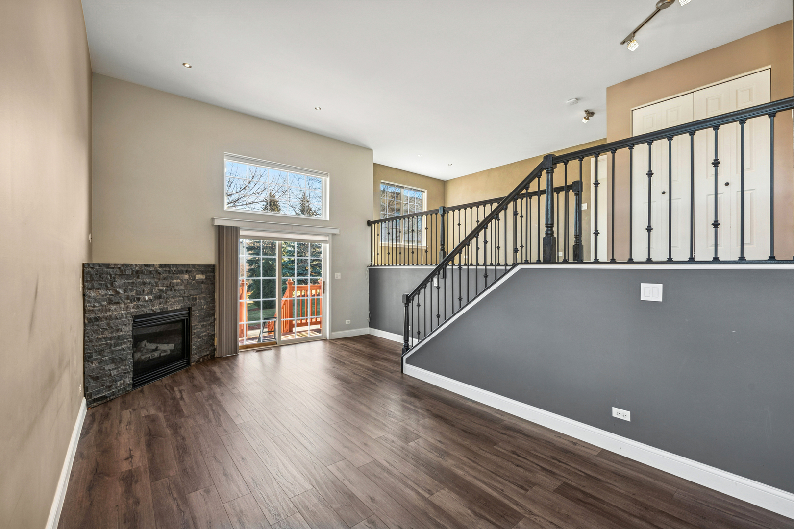 651 Georgian Court Addison, IL 60101 - Photo 4 of 24 a view of an empty room with wooden floor fireplace and a window
