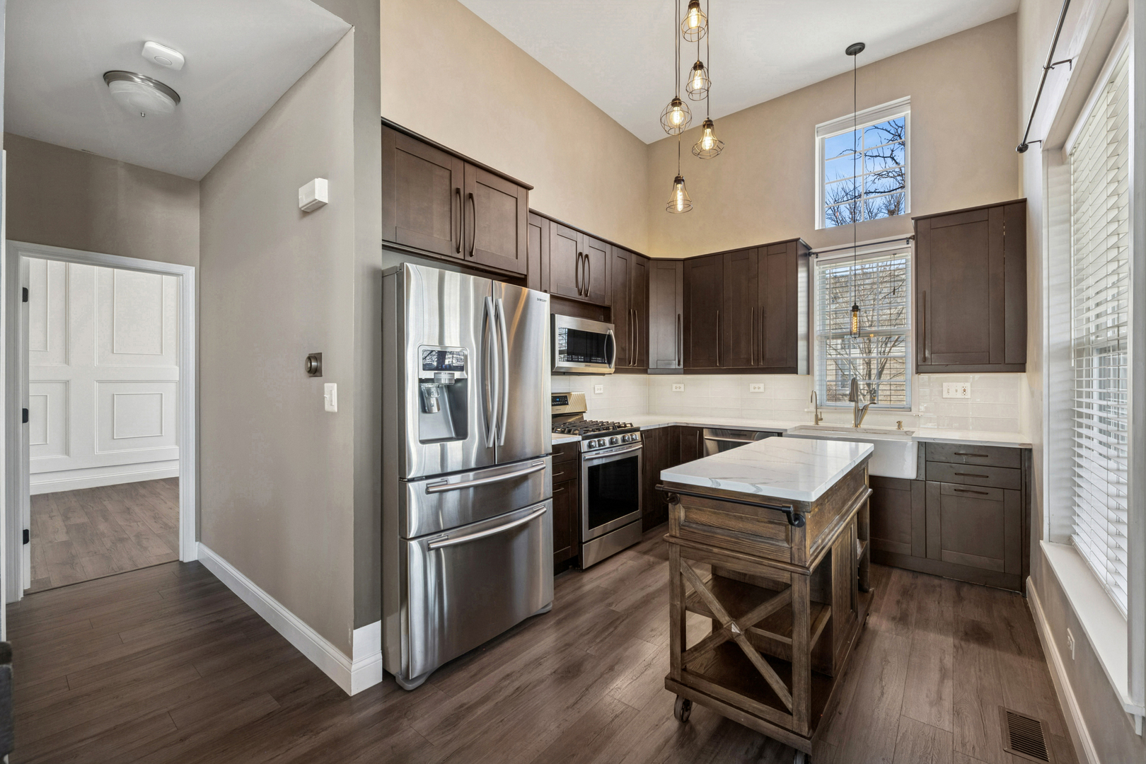 651 Georgian Court Addison, IL 60101 - Photo 8 of 24 a kitchen with stainless steel appliances a stove a refrigerator and a sink