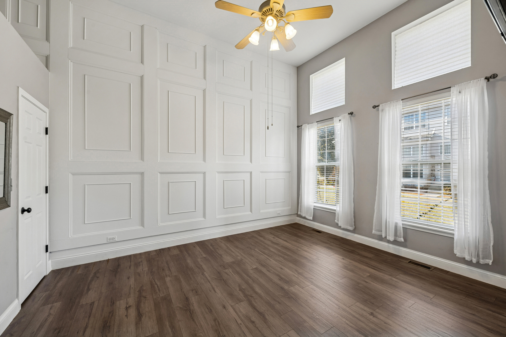 651 Georgian Court Addison, IL 60101 - Photo 10 of 24 a view of an empty room with wooden floor and window