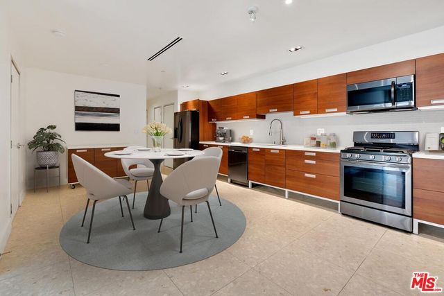 a dining room with furniture and a kitchen view