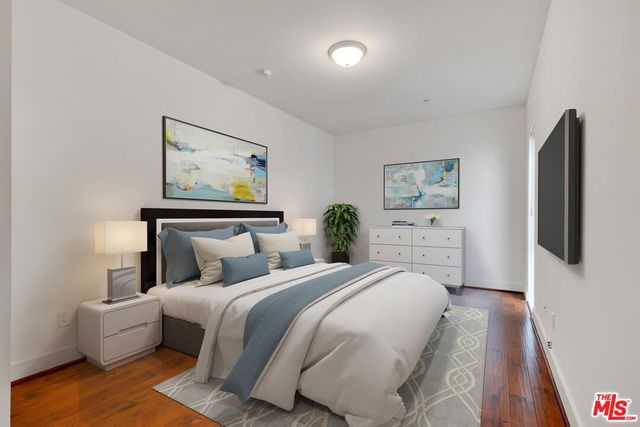 a bedroom with a bed and a flat screen tv