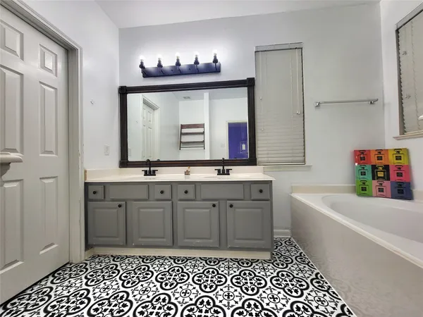 a bathroom with a sink a vanity and a mirror