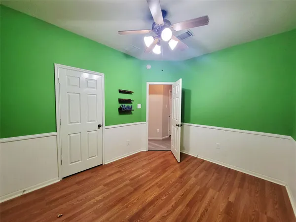en empty room with window and wooden floor