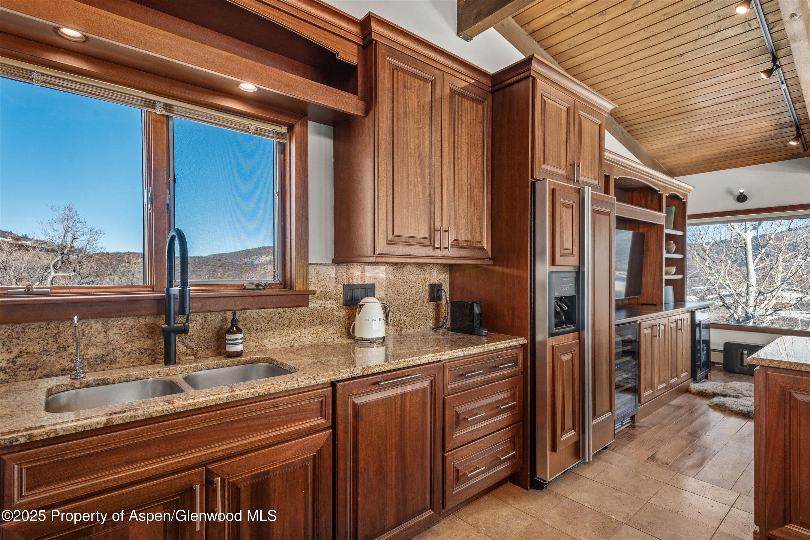 2227 Juniper Hill Road Aspen, CO 81611 - Photo 13 of 40 a kitchen with stainless steel appliances granite countertop a sink stove and cabinets