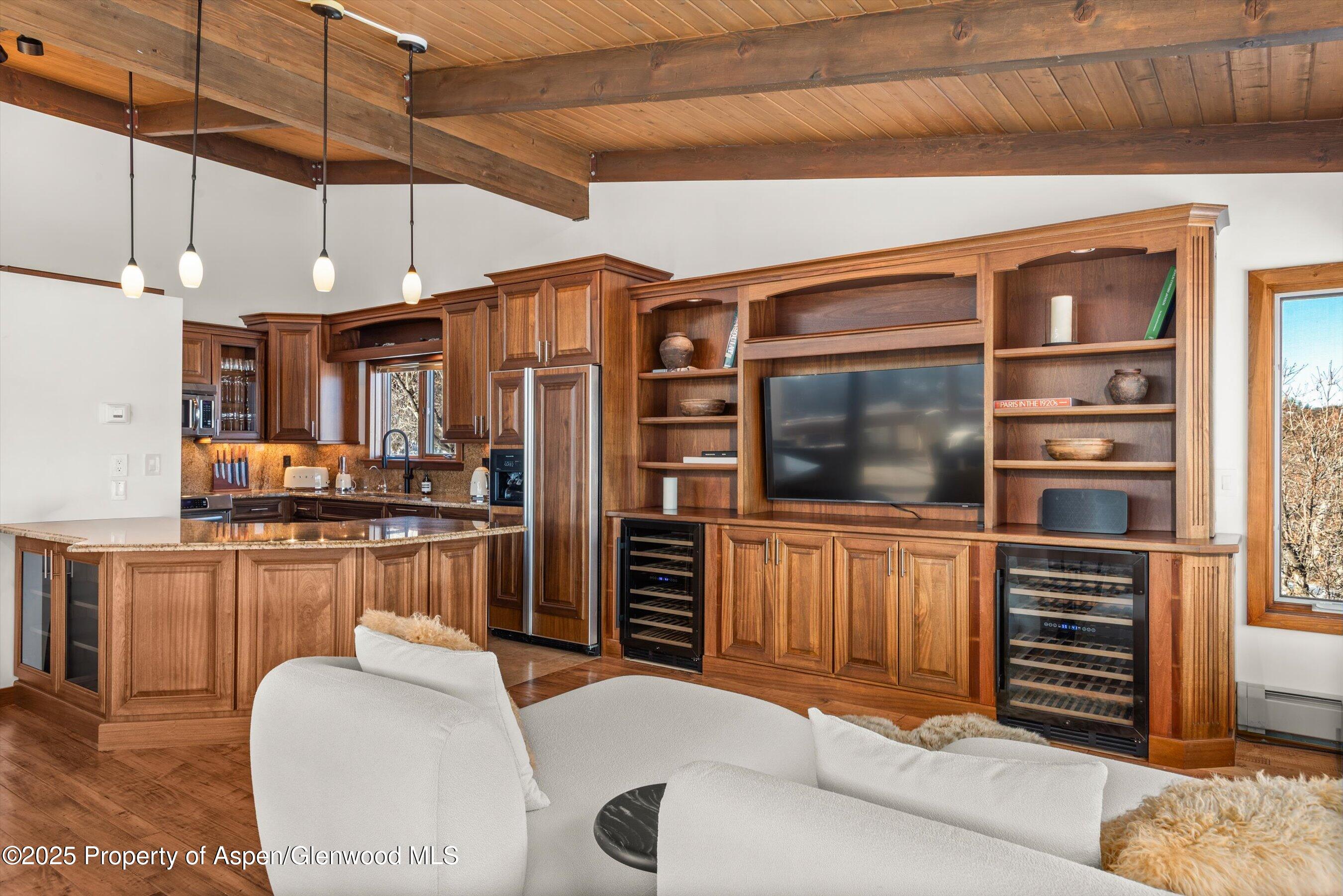 2227 Juniper Hill Road Aspen, CO 81611 - Photo 20 of 40 a living room with furniture a flat screen tv and kitchen view