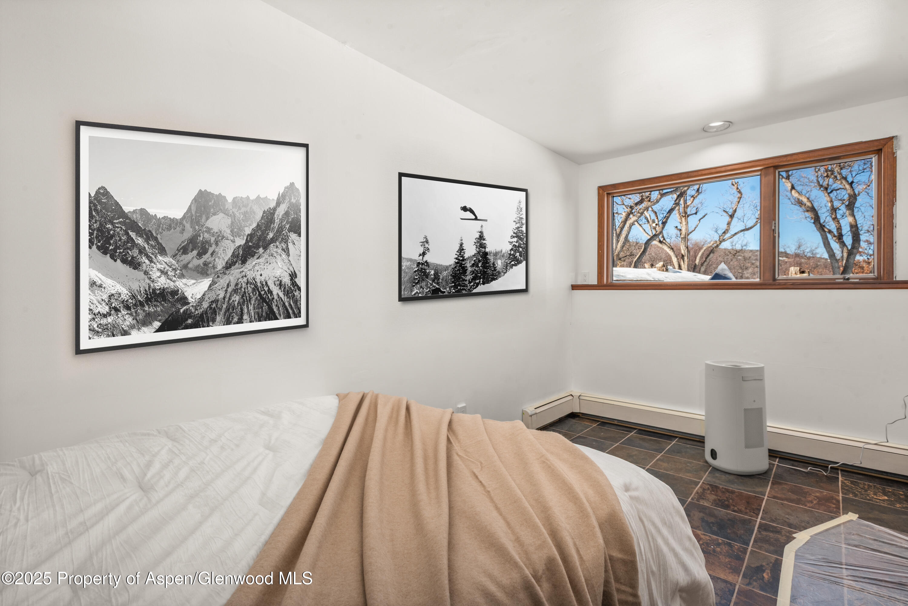 2227 Juniper Hill Road Aspen, CO 81611 - Photo 27 of 40 a bedroom with a bed and a painting on the wall