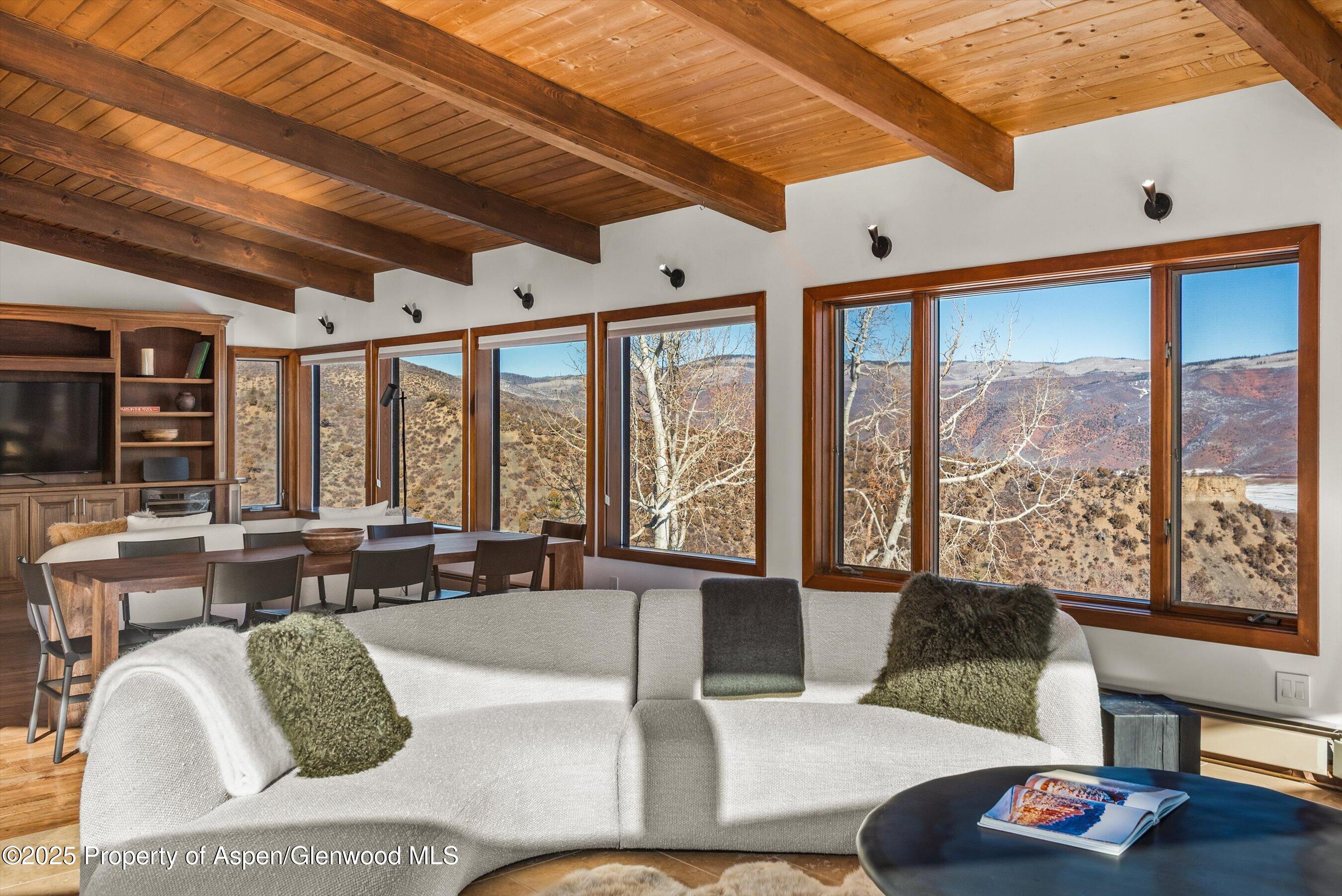 2227 Juniper Hill Road Aspen, CO 81611 - Photo 3 of 40 a living room with furniture and floor to ceiling windows