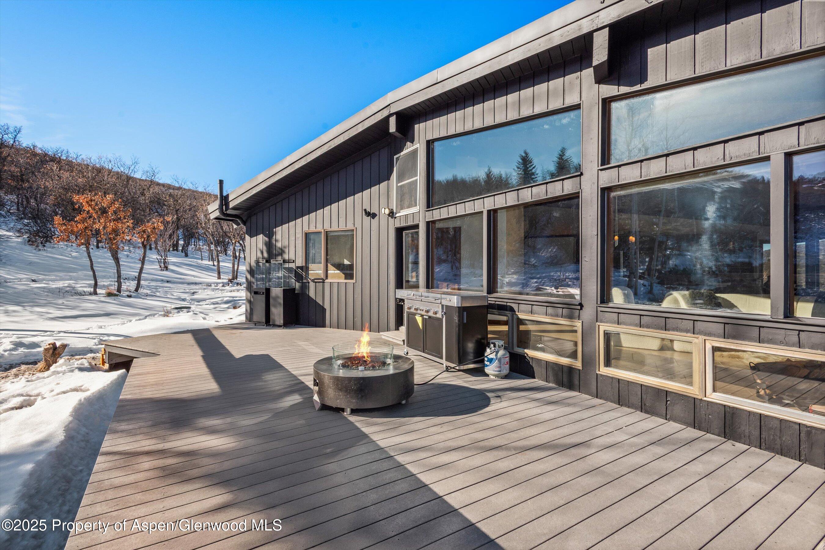 2227 Juniper Hill Road Aspen, CO 81611 - Photo 33 of 40 a view of a patio with swimming pool table and chairs