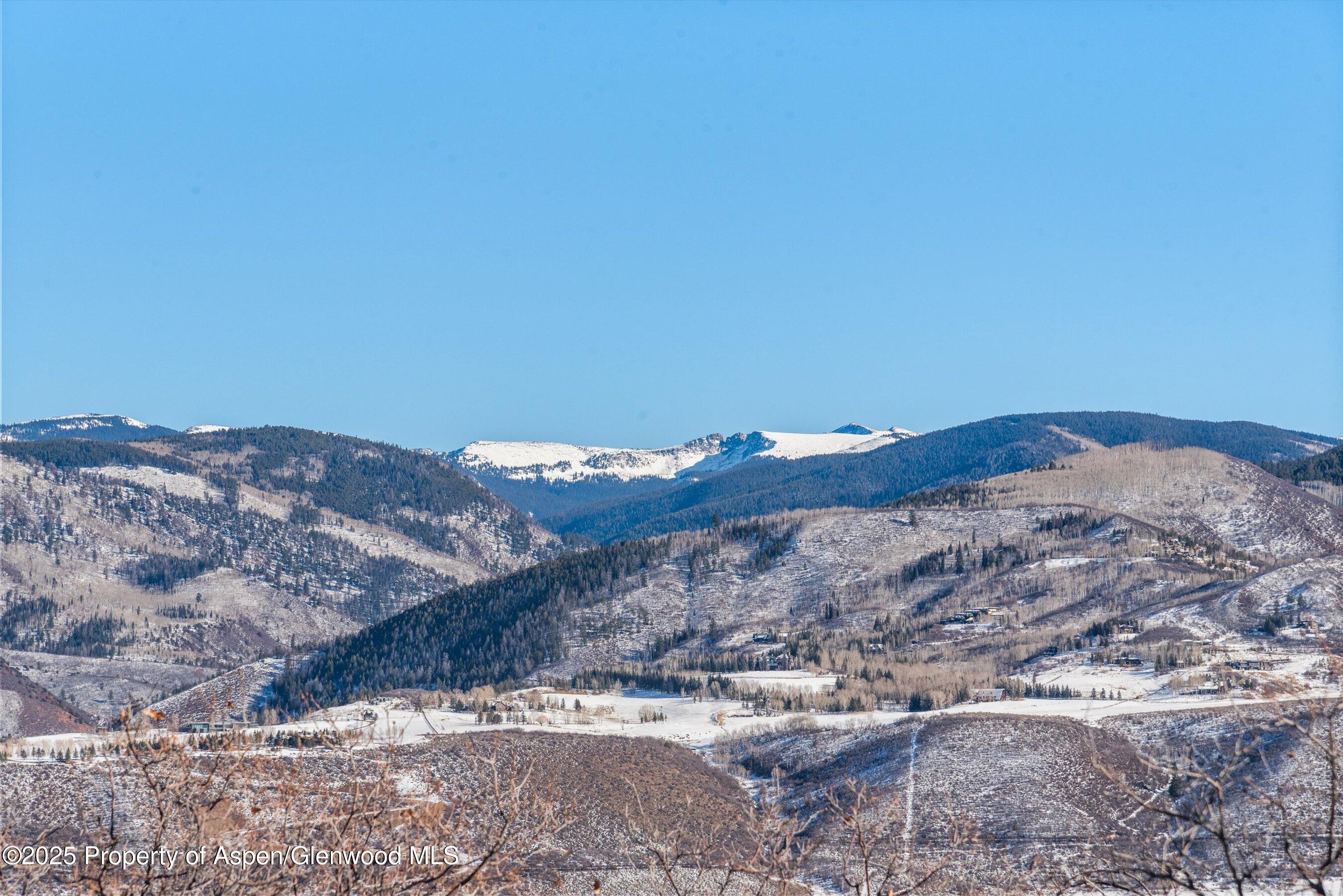 2227 Juniper Hill Road Aspen, CO 81611 - Photo 40 of 40 a view of a large building with mountain in background