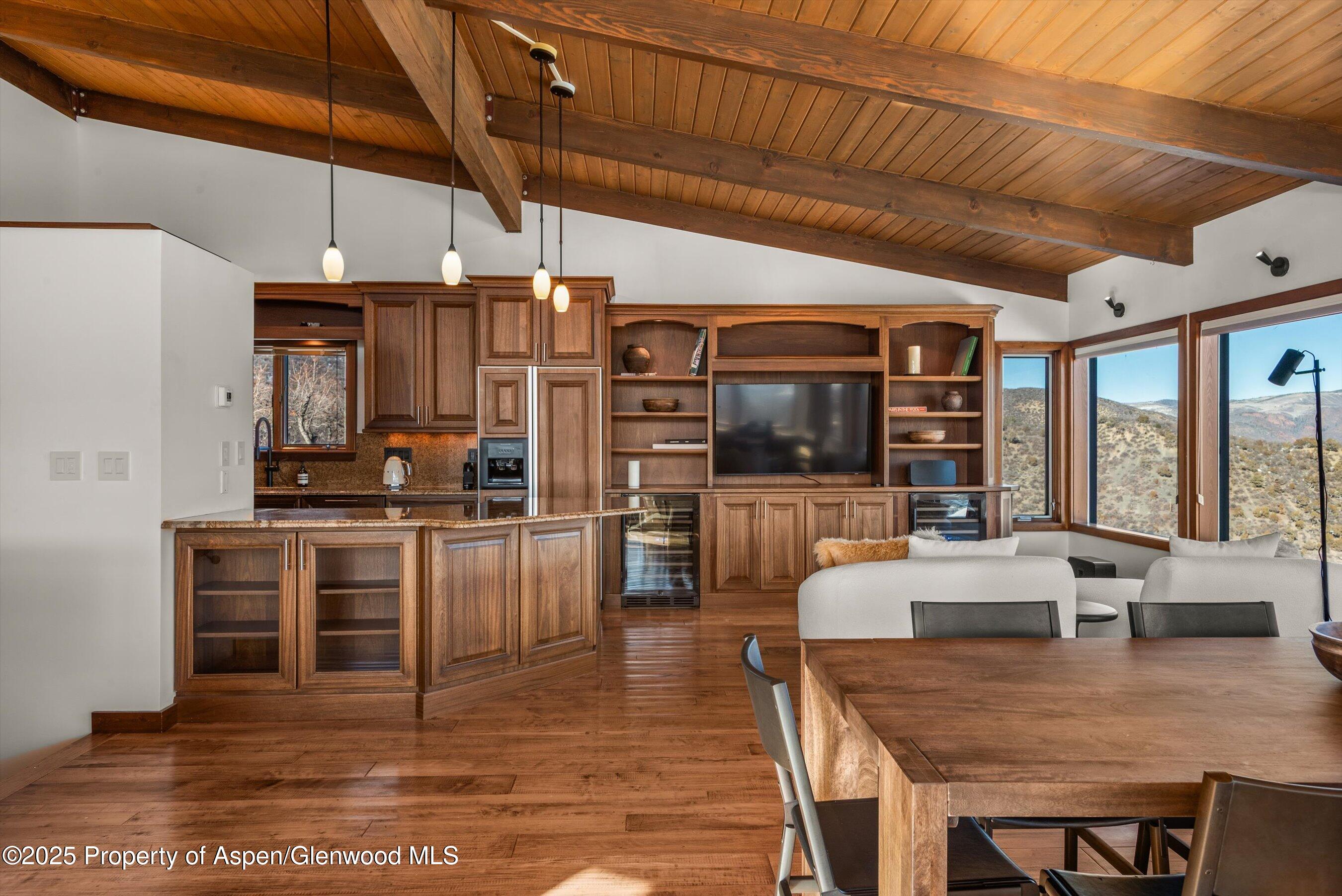2227 Juniper Hill Road Aspen, CO 81611 - Photo 10 of 40 a large kitchen with a table chairs stove and refrigerator