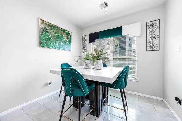 a view of a dining room with furniture and window
