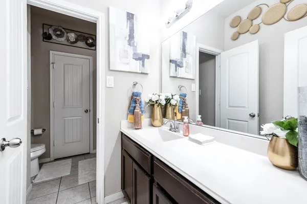 a bathroom with a sink a vanity and a mirror