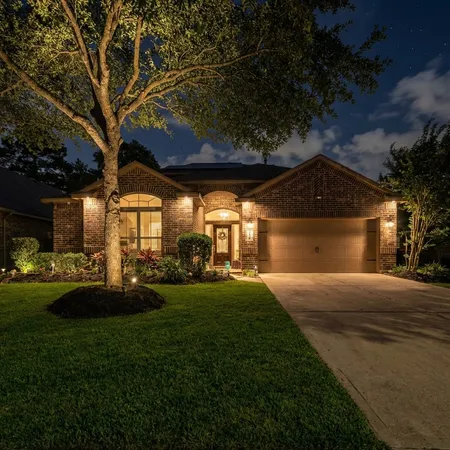 a front view of a house with a garden and patio